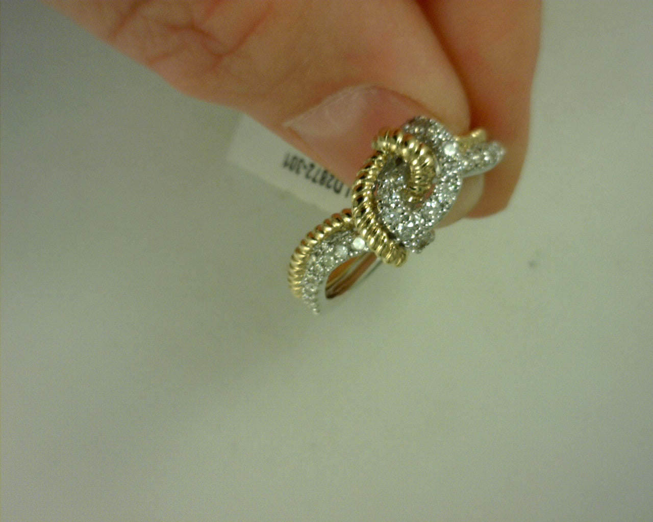 14 KT. TWO TONED DIAMOND LOVE KNOT RING<br>SIZE 7<br>TDW .43