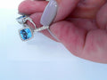 diamond and blue topaz drop earring in 14 karat white gold