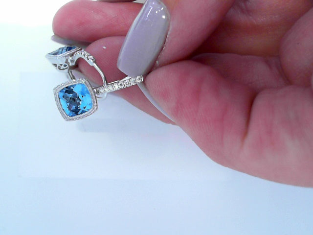 diamond and blue topaz drop earring in 14 karat white gold