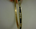 14 karat yellow gold diamond and saphire bangle 14.8g .6ct saph  .54 ct diamonds