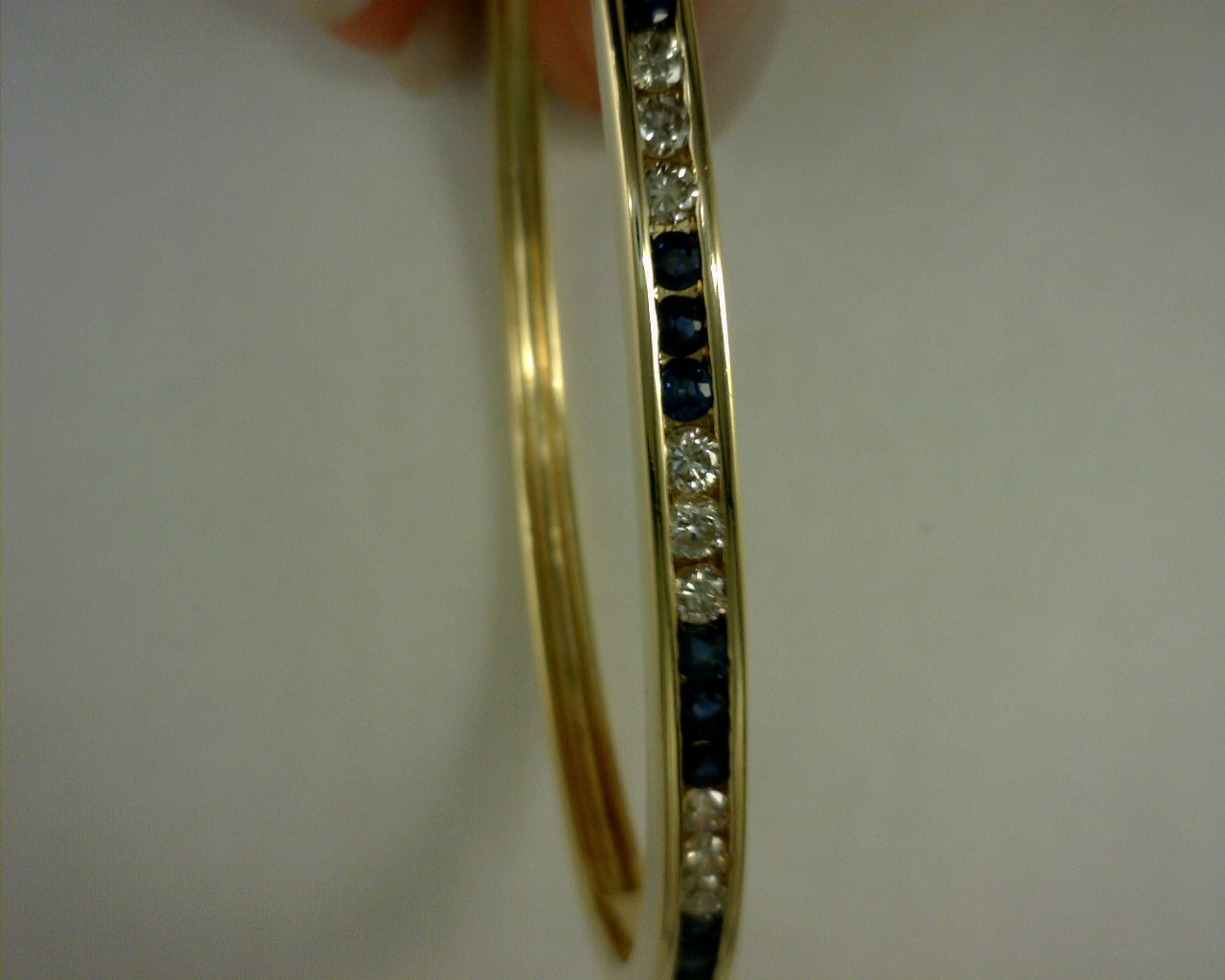 14 karat yellow gold diamond and saphire bangle 14.8g .6ct saph  .54 ct diamonds