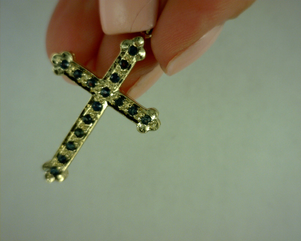 14 karat yellow gold cross with sapphires